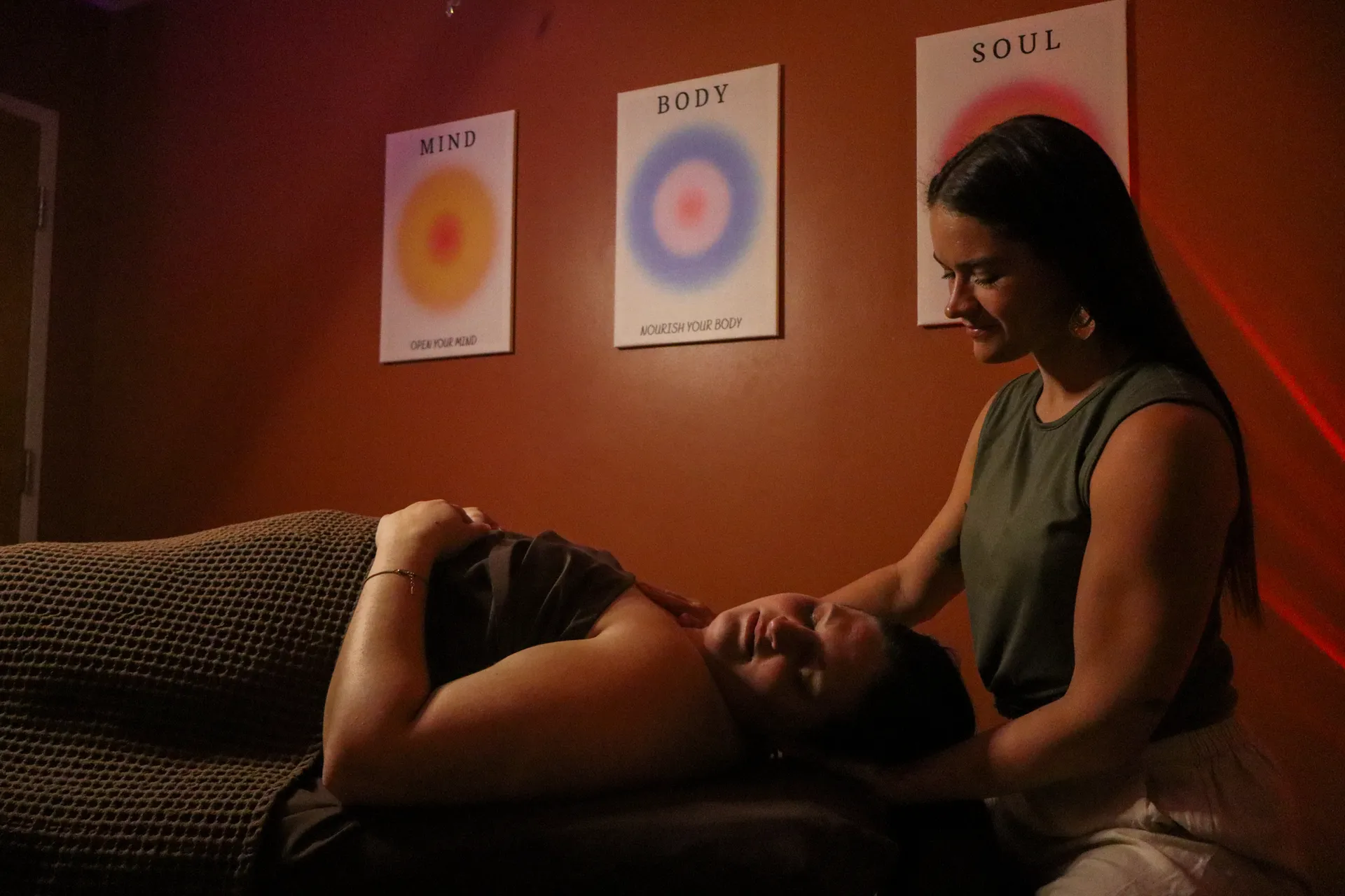 Intuitive therapeutic massage in a warm, candlelit room